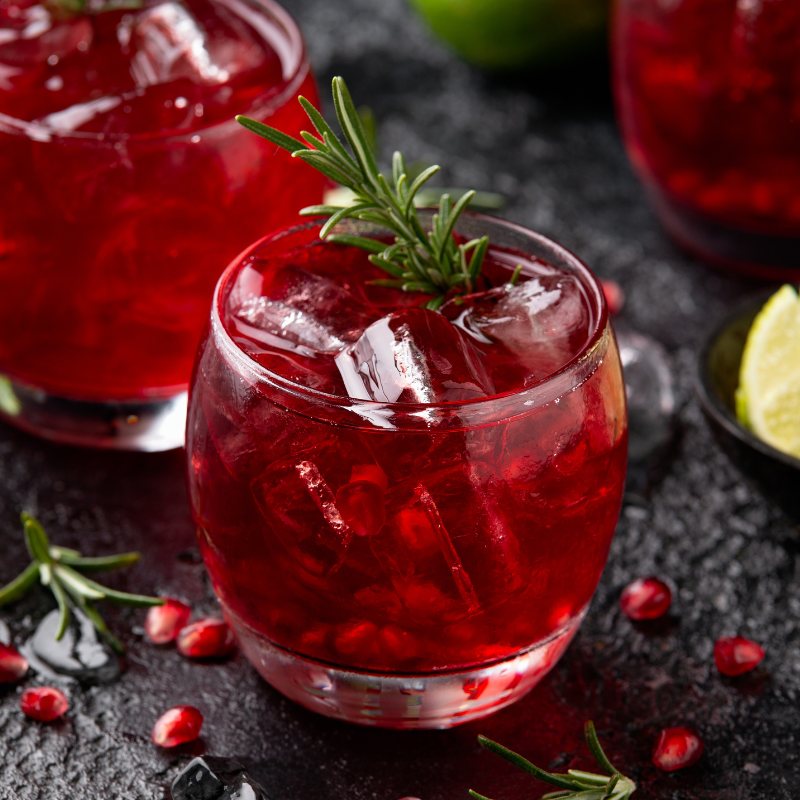 Two glasses of gin cocktail and pomegranates